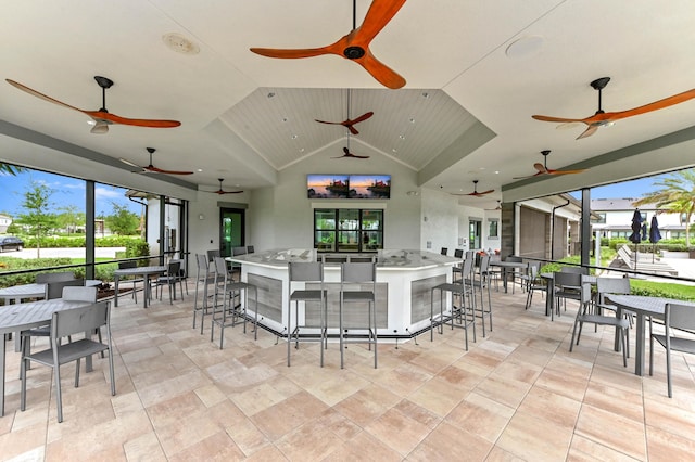 view of patio / terrace with outdoor wet bar, ceiling fan, and outdoor dining space