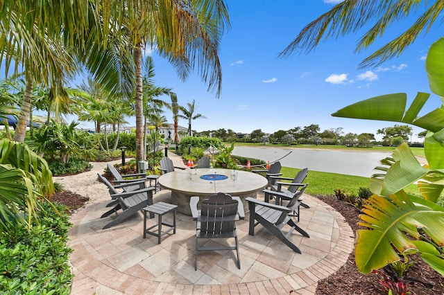 view of patio with outdoor dining space and a water view