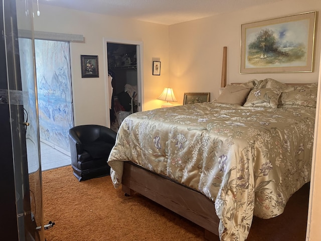 bedroom with a walk in closet and carpet