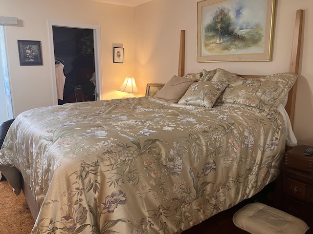 bedroom with a closet, a spacious closet, and carpet