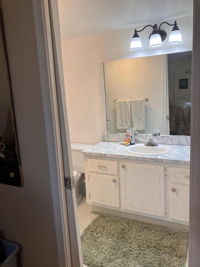 bathroom with toilet and vanity