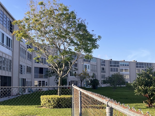 surrounding community with a lawn and fence
