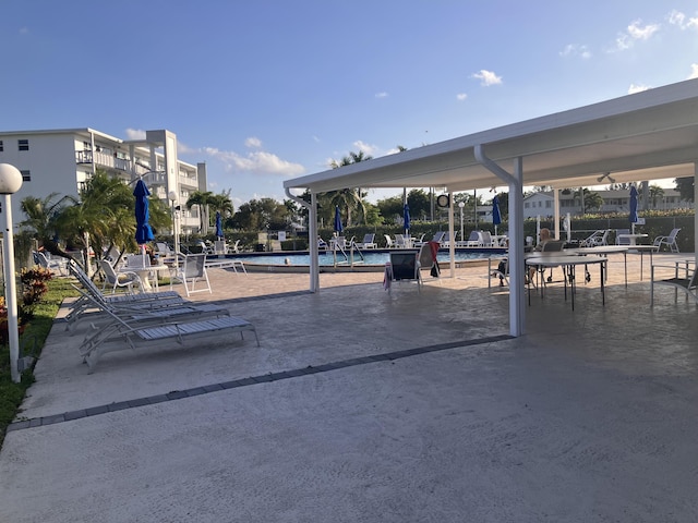 view of home's community with a pool and a patio area