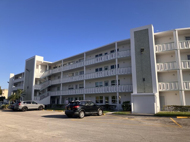 view of property with uncovered parking
