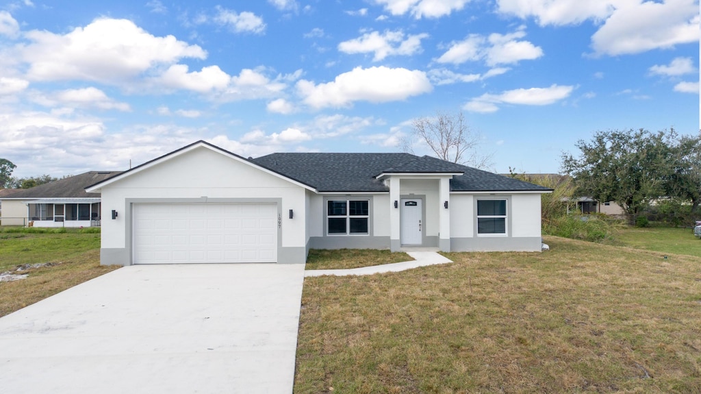 ranch-style home featuring concrete driveway, a front yard, roof with shingles, stucco siding, and a garage