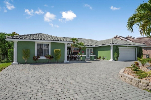 11408 NW 20th Dr, Coral Springs, FL 33071 - view of front of home with a tiled roof, decorative driveway, a garage, and stucco siding