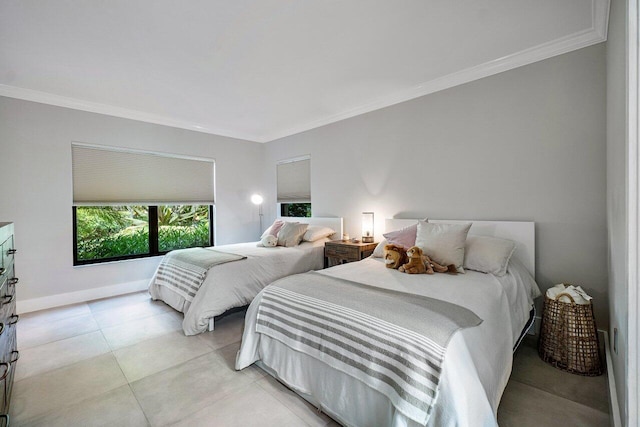 bedroom with light tile patterned floors, baseboards, and ornamental molding