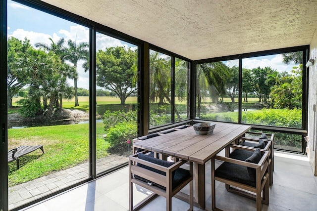 sunroom / solarium featuring a healthy amount of sunlight and a water view