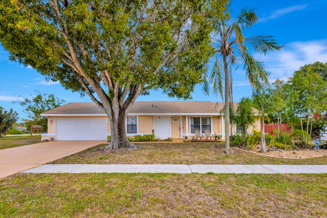 ranch-style home with a garage, fence, concrete driveway, and stucco siding