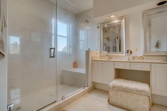 bathroom with a stall shower, tile patterned flooring, and vanity