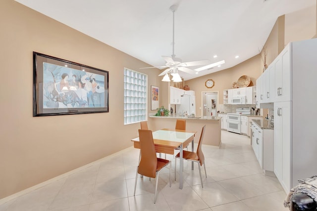 12589 Via Ravenna, Boynton Beach, FL 33436 - dining space with light tile patterned floors, baseboards, recessed lighting, ceiling fan, and lofted ceiling with skylight