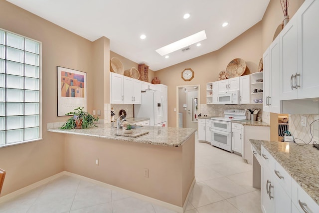 12589 Via Ravenna, Boynton Beach, FL 33436 - kitchen with open shelves, decorative backsplash, white appliances, and a sink