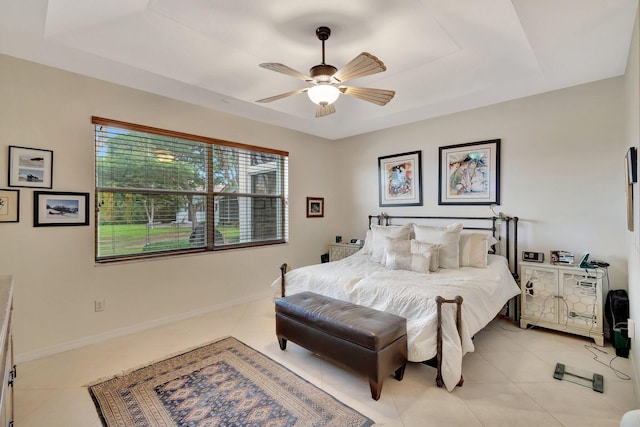 12589 Via Ravenna, Boynton Beach, FL 33436 - bedroom featuring light tile patterned floors, ceiling fan, a raised ceiling, and baseboards