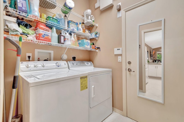 12589 Via Ravenna, Boynton Beach, FL 33436 - laundry area with tile patterned floors, baseboards, washing machine and dryer, and laundry area