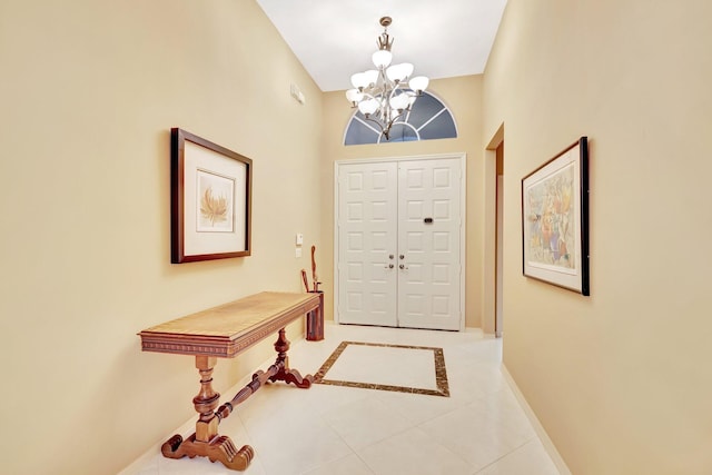 12589 Via Ravenna, Boynton Beach, FL 33436 - foyer featuring light tile patterned floors, baseboards, and an inviting chandelier