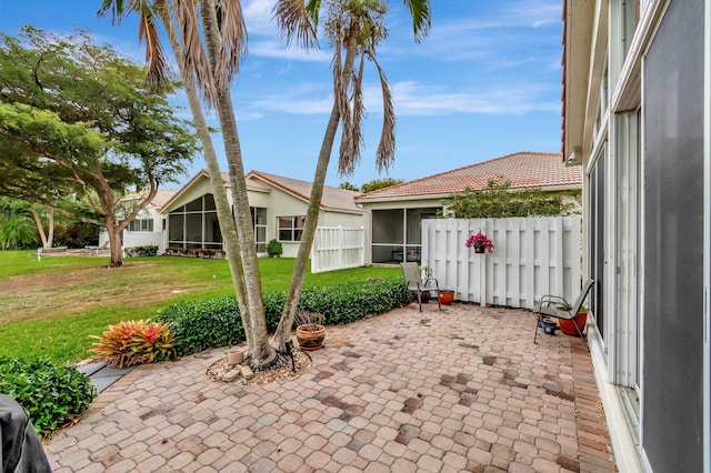 12589 Via Ravenna, Boynton Beach, FL 33436 - view of patio / terrace with fence and a sunroom