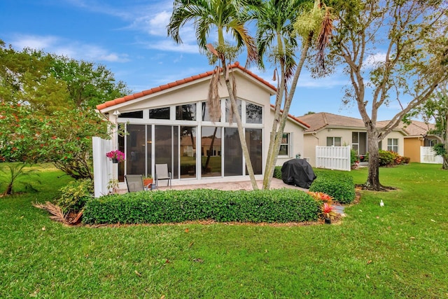12589 Via Ravenna, Boynton Beach, FL 33436 - back of house featuring a tiled roof, a yard, a sunroom, and stucco siding