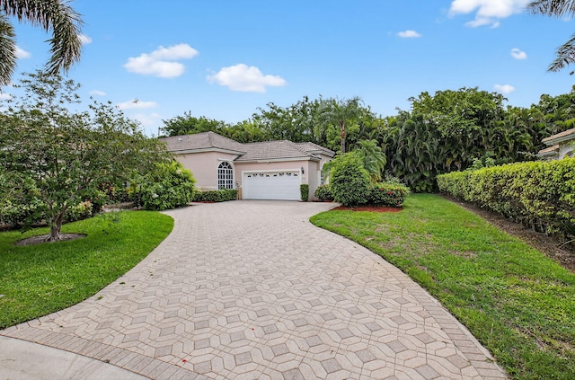 9025 Long Lake Palm Dr, Boca Raton, FL 33496 - view of front of home with decorative driveway, a garage, stucco siding, and a front yard