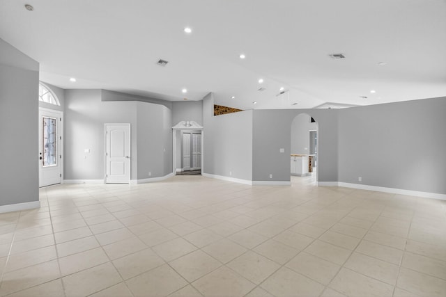 9025 Long Lake Palm Dr, Boca Raton, FL 33496 - unfurnished living room with arched walkways, recessed lighting, high vaulted ceiling, light tile patterned flooring, and baseboards