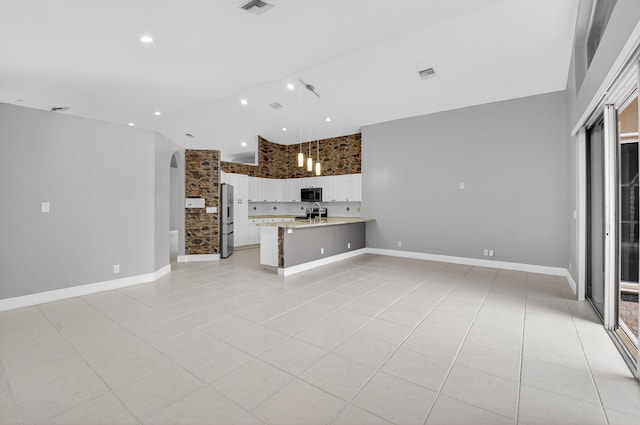 9025 Long Lake Palm Dr, Boca Raton, FL 33496 - unfurnished living room featuring light tile patterned flooring, a towering ceiling, and recessed lighting