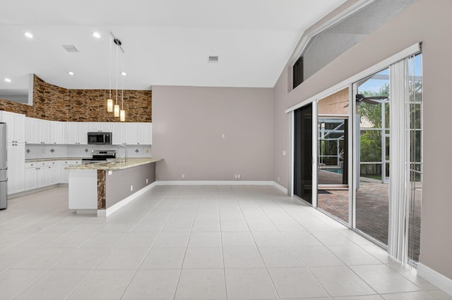 9025 Long Lake Palm Dr, Boca Raton, FL 33496 - kitchen with appliances with stainless steel finishes, high vaulted ceiling, a peninsula, a sink, and white cabinetry
