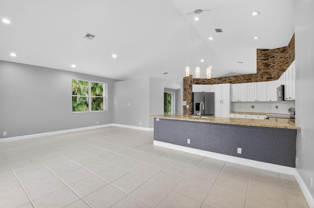 9025 Long Lake Palm Dr, Boca Raton, FL 33496 - kitchen featuring appliances with stainless steel finishes, light stone countertops, high vaulted ceiling, white cabinets, and light tile patterned flooring