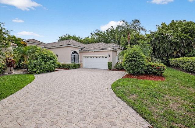 9025 Long Lake Palm Dr, Boca Raton, FL 33496 - view of front of home featuring stucco siding, an attached garage, decorative driveway, and a tile roof