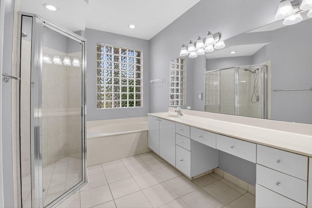9025 Long Lake Palm Dr, Boca Raton, FL 33496 - bathroom featuring double vanity, a shower stall, a garden tub, tile patterned floors, and recessed lighting