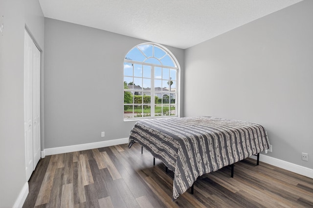 9025 Long Lake Palm Dr, Boca Raton, FL 33496 - bedroom with baseboards, wood finished floors, and a closet