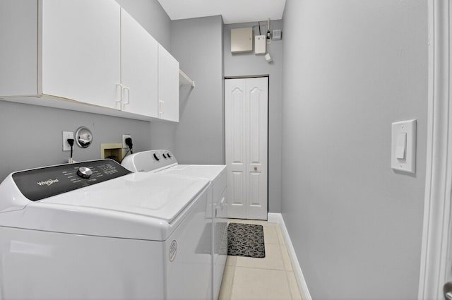 9025 Long Lake Palm Dr, Boca Raton, FL 33496 - washroom featuring washing machine and dryer, cabinet space, tile patterned floors, and baseboards