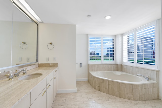 529 S Flagler Dr Unit 6E, West Palm Beach, FL 33401 - bathroom featuring vanity, a garden tub, and baseboards