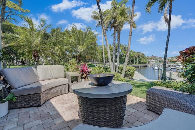 view of patio featuring an outdoor hangout area, a dock, and a water view