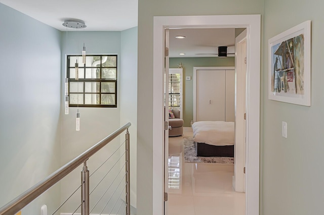 hallway with recessed lighting and an upstairs landing