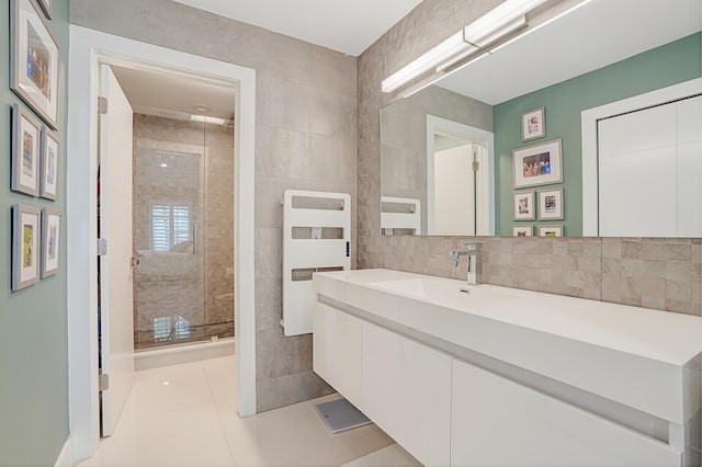 bathroom featuring tile walls, a stall shower, vanity, and tile patterned flooring