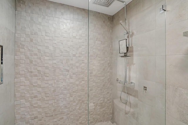 full bath featuring tiled shower