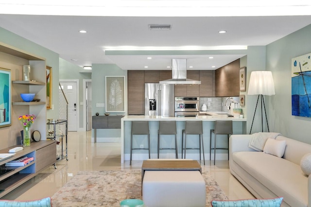 living area featuring recessed lighting and visible vents