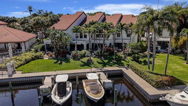 view of dock featuring a yard and a water view