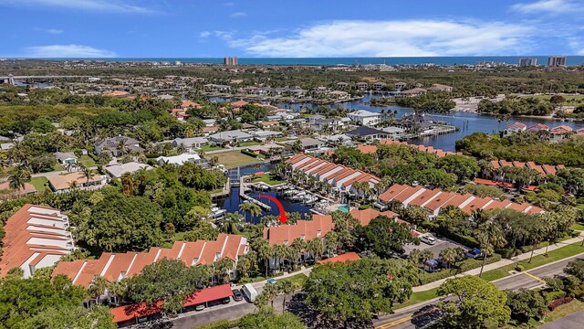 drone / aerial view featuring a residential view and a water view