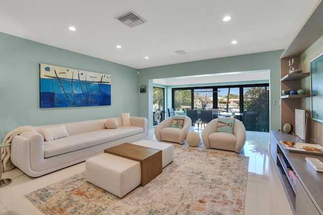 tiled living room with recessed lighting and visible vents