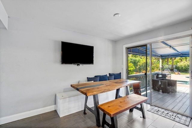 dining space with baseboards and a sunroom