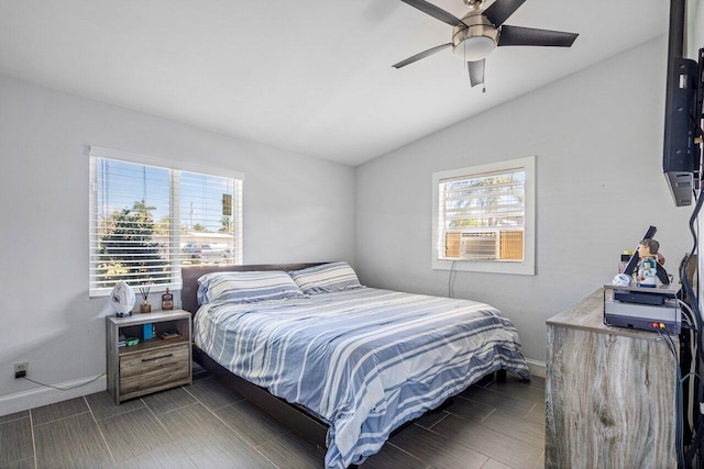 bedroom featuring lofted ceiling, baseboards, and ceiling fan