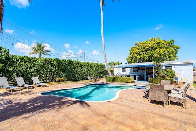 view of swimming pool with a patio, a fenced in pool, and fence