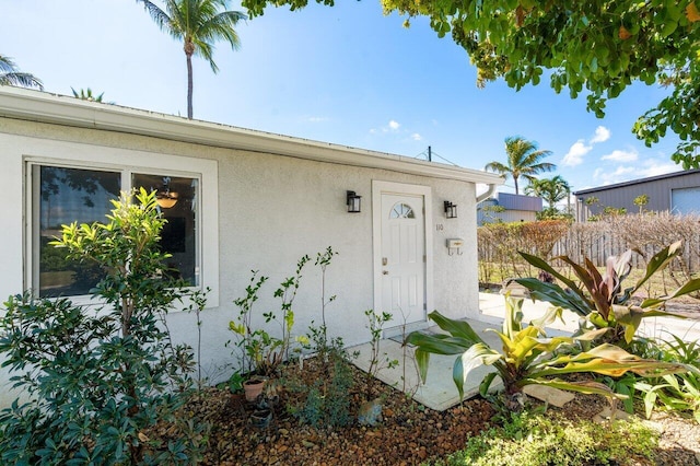 doorway to property with stucco siding