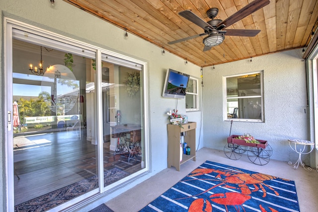 exterior space featuring ceiling fan with notable chandelier