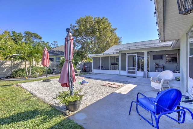 view of patio / terrace with fence and a sunroom