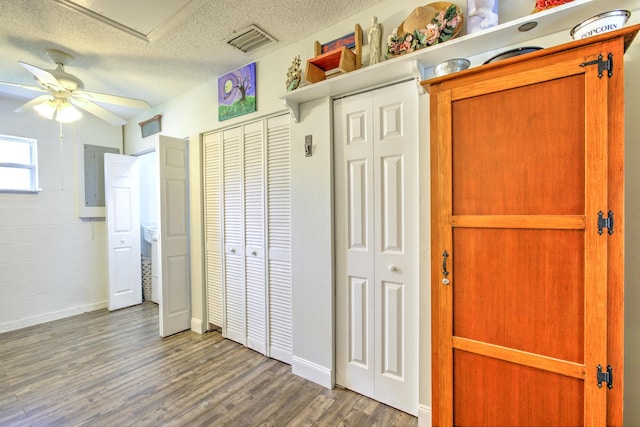unfurnished bedroom featuring visible vents, a textured ceiling, and wood finished floors