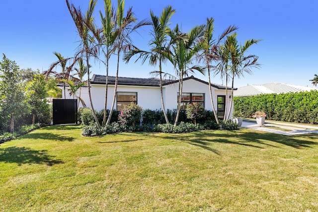 exterior space with a front yard and stucco siding