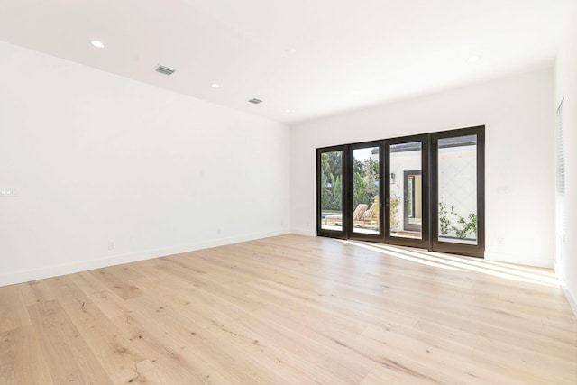empty room with recessed lighting, visible vents, baseboards, and light wood-style floors