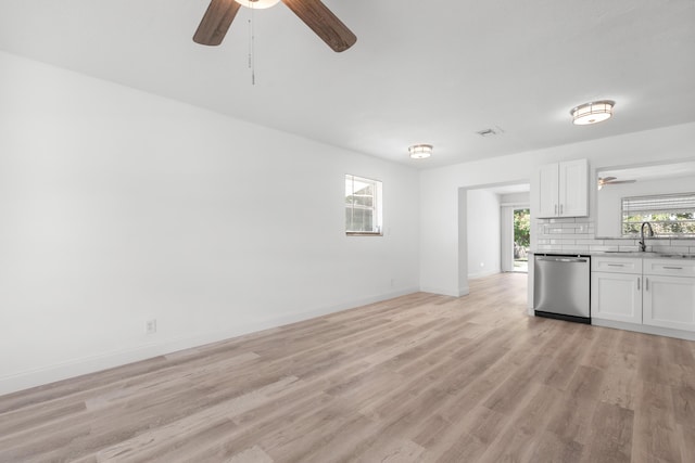 991 SW 31st St, Fort Lauderdale, FL 33315 - kitchen featuring ceiling fan, light wood-type flooring, stainless steel dishwasher, white cabinetry, and a sink