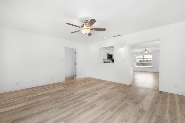 991 SW 31st St, Fort Lauderdale, FL 33315 - unfurnished living room with a ceiling fan, light wood-style floors, and baseboards